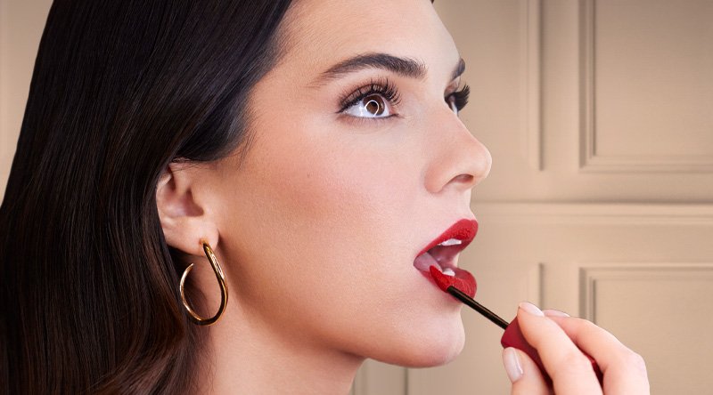 Modelo aplicándose el labial líquido Matte Resistance Infallible